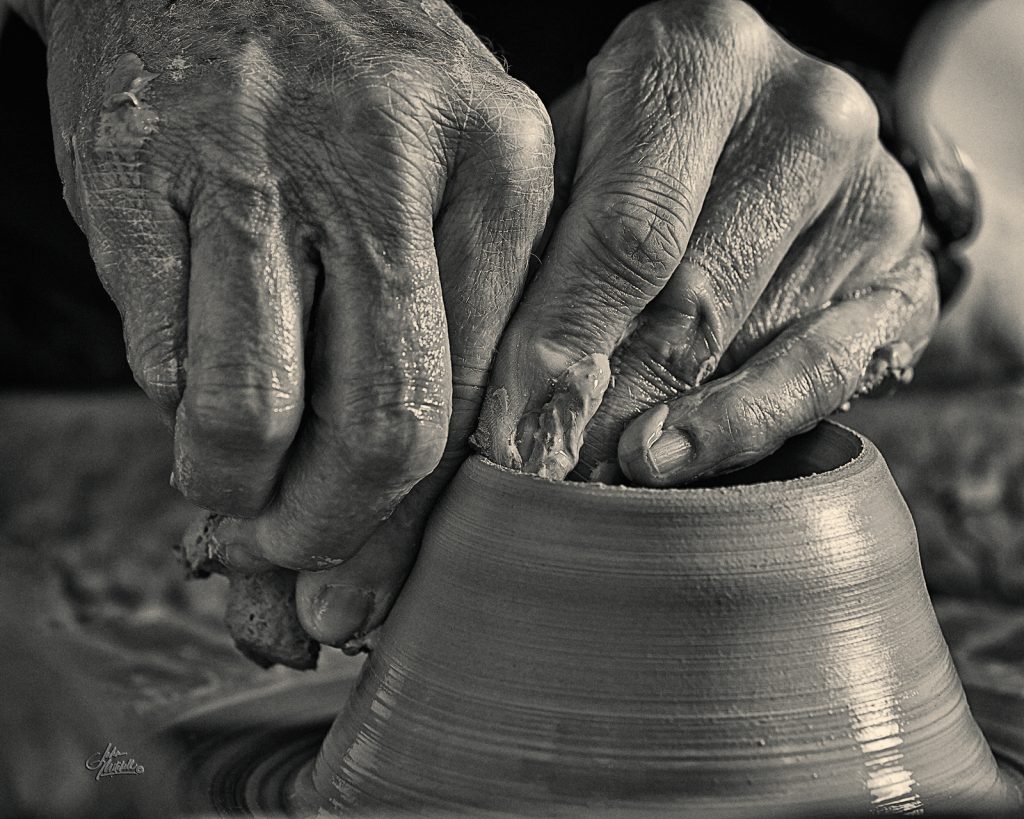 photograph of potter's hands at work