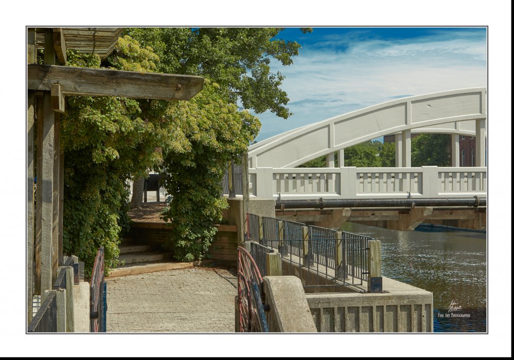 Colour photograph of the Main Street bridge and the Grand River as seen from Melville Café.